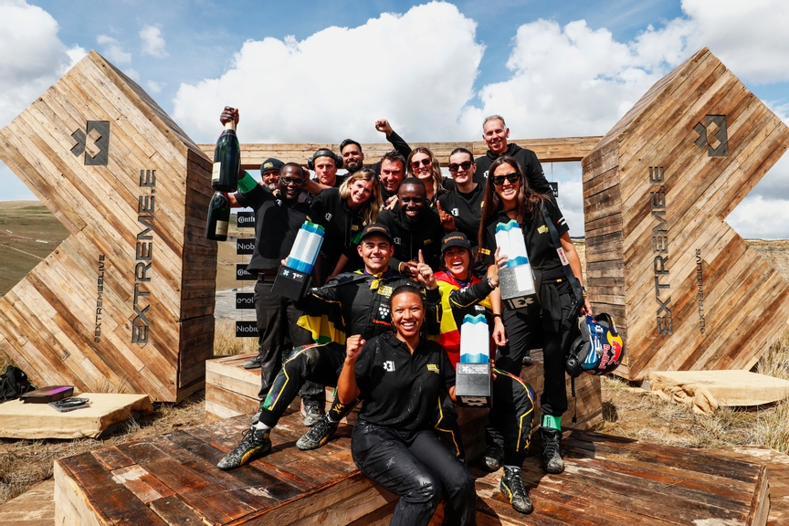 MAY 13: Fraser McConnell (JAM), X44 Vida Carbon Racing, and Cristina Gutierrez (ESP), X44 Vida Carbon Racing, 1st position, celebrate with their team mates on the podium during the Scotland X-Prix on May 13, 2023. (Photo by Sam Bloxham / LAT Images)