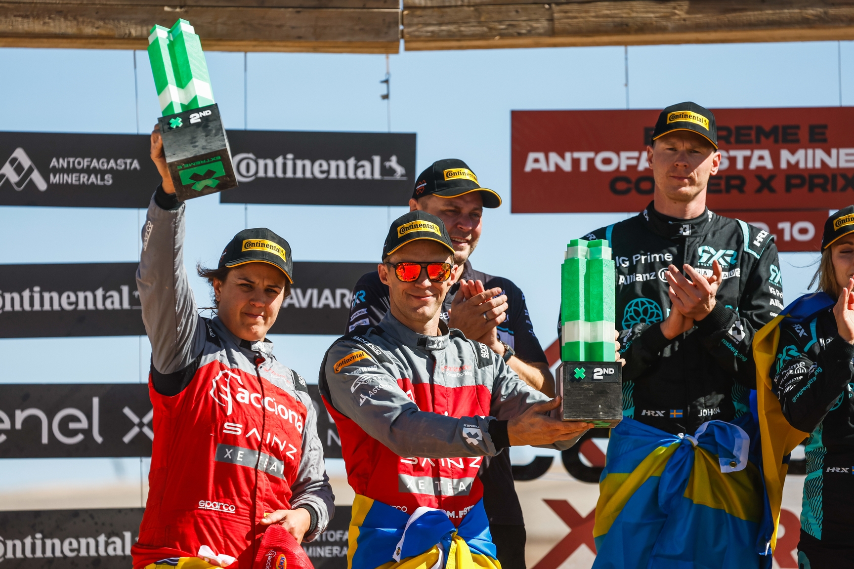 DECEMBER 03: Laia Sanz (ESP) / Mattias Ekstrom (SWE), Acciona | Sainz XE Team, 2nd position, with their trophies on the championship podium during the Copper X-Prix, Chile on December 03, 2023. (Photo by Sam Bloxham / LAT Images)